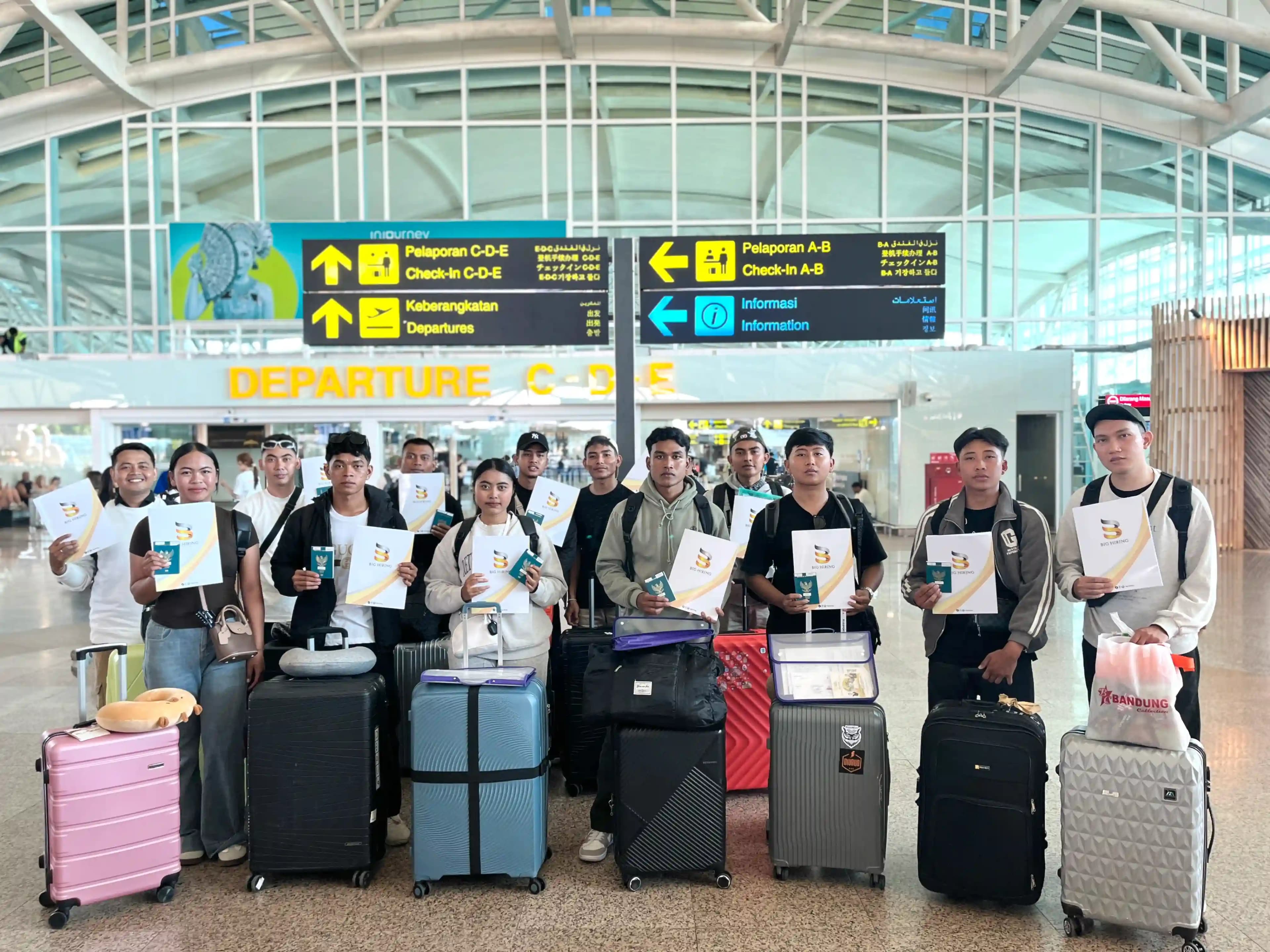 Big Hiring candidates holding travel documents and luggage at an airport